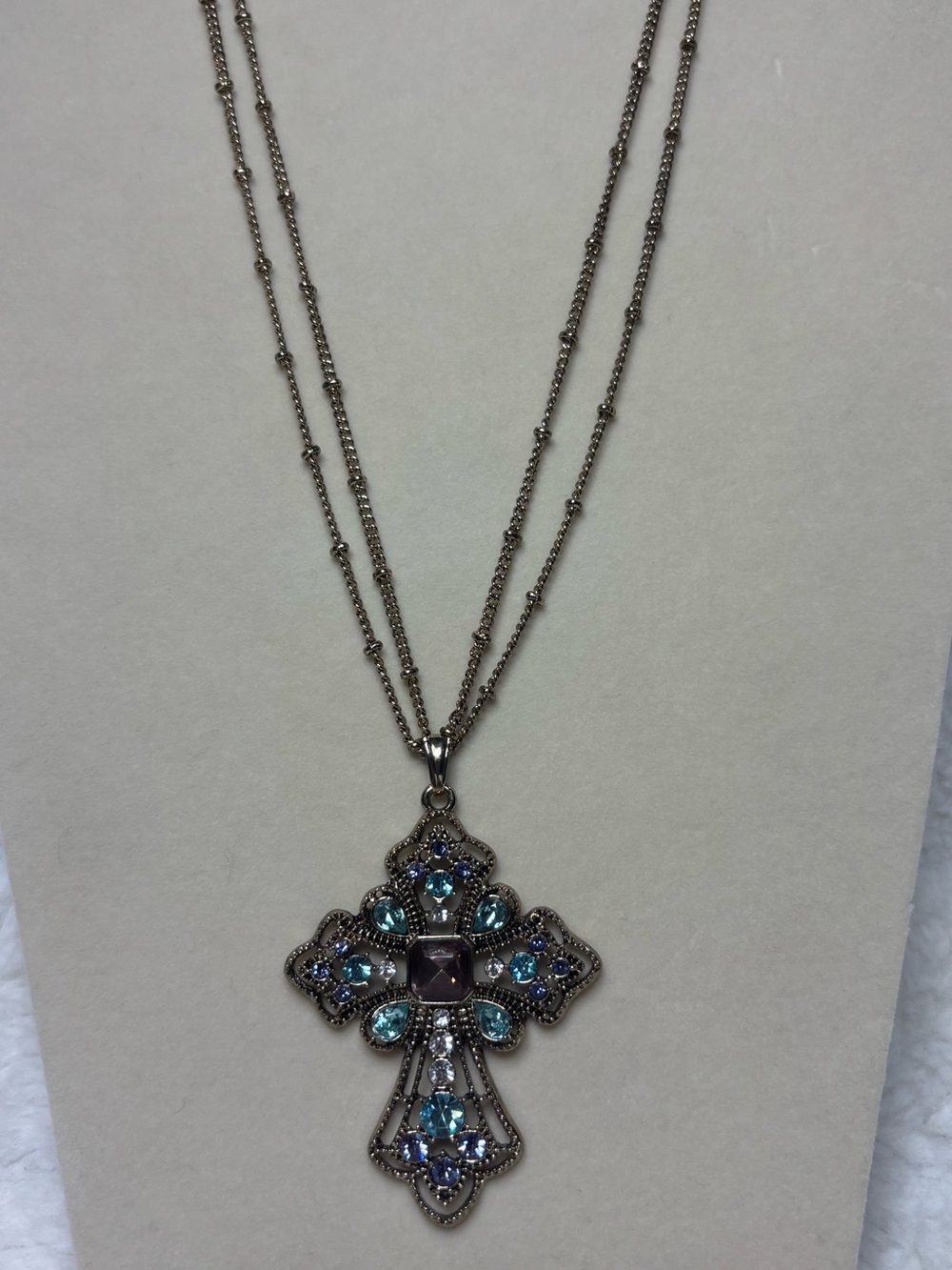Multi strand gold tone necklace embellished cross aquamarine & amethyst stones